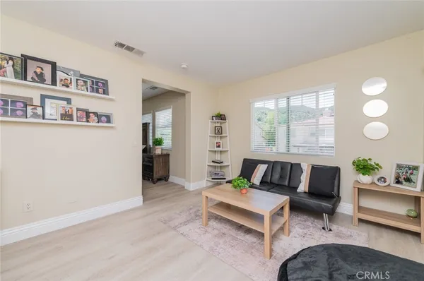 a living room with patio furniture and a floor to ceiling window