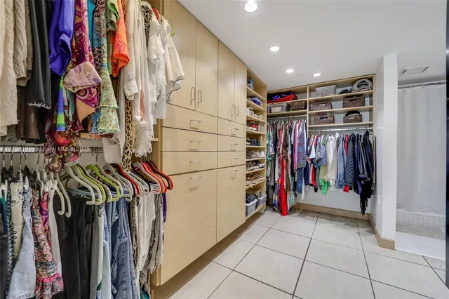 a view of walk in closet with clothes