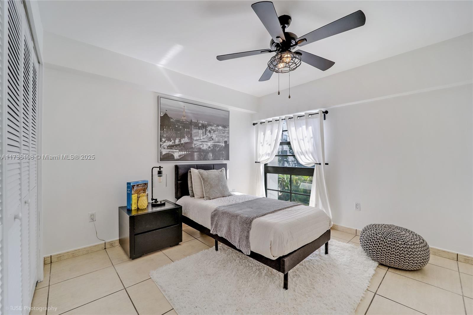 575 Crandon Boulevard, Unit 306 Key Biscayne, FL 33149 - Photo 12 of 18 a bedroom with a bed and a chandelier