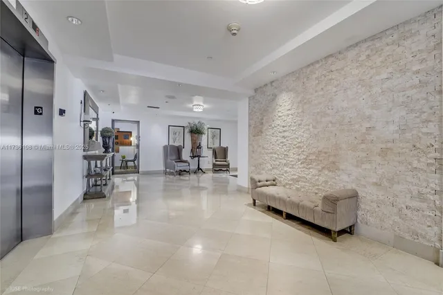 a living room with furniture and a book shelf