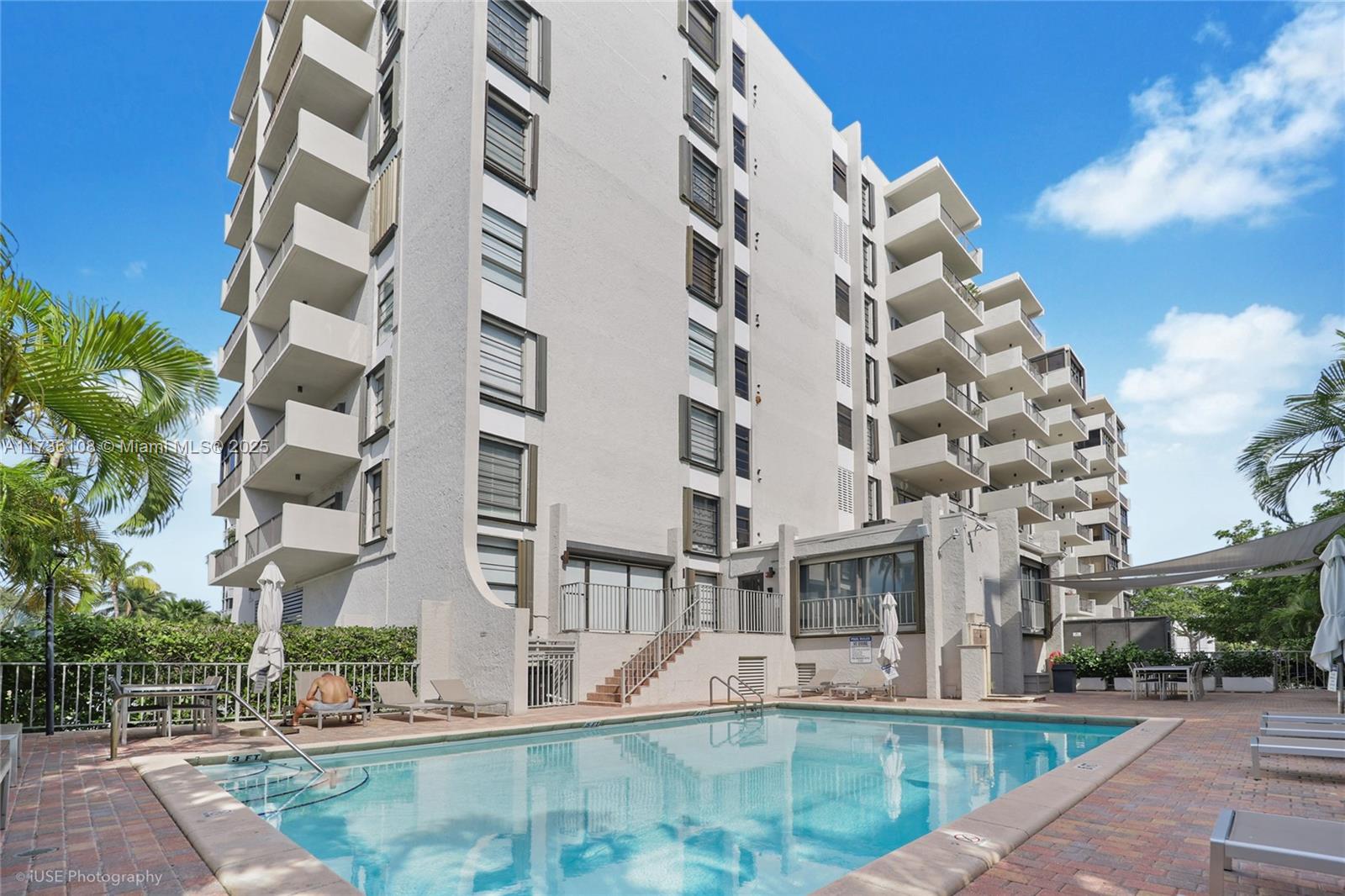 575 Crandon Boulevard, Unit 306 Key Biscayne, FL 33149 - Photo 17 of 18 front view of building with a yard