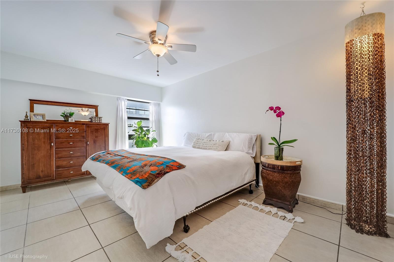 575 Crandon Boulevard, Unit 306 Key Biscayne, FL 33149 - Photo 7 of 18 a bedroom with a bed and a chandelier