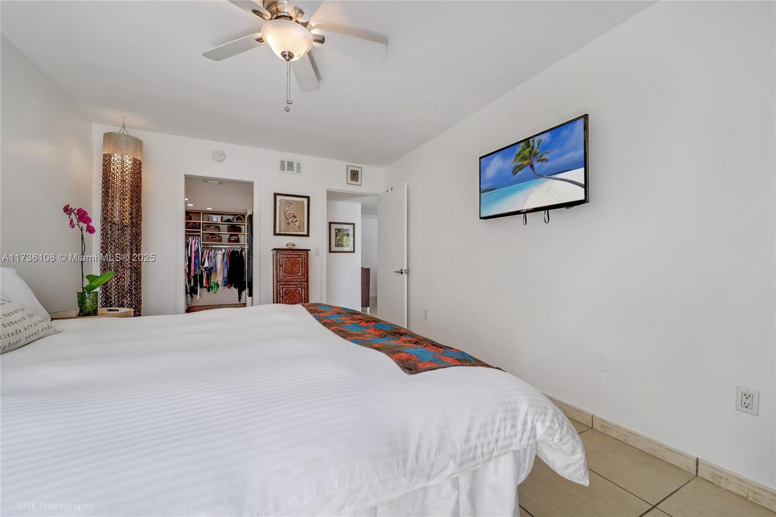 575 Crandon Boulevard, Unit 306 Key Biscayne, FL 33149 - Photo 8 of 18 a bedroom with bed and a chandelier