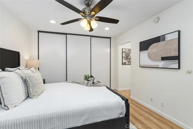 a bedroom with a large bed and a chandelier