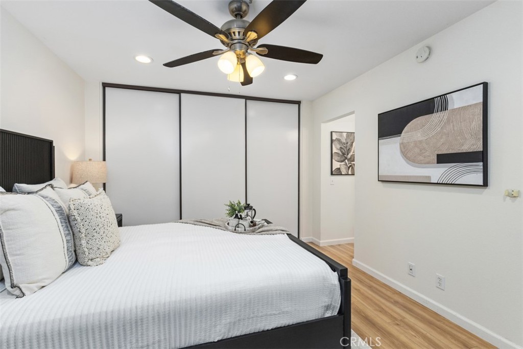 56 Windjammer Irvine, CA 92614 - Photo 14 of 31 a bedroom with a large bed and a chandelier