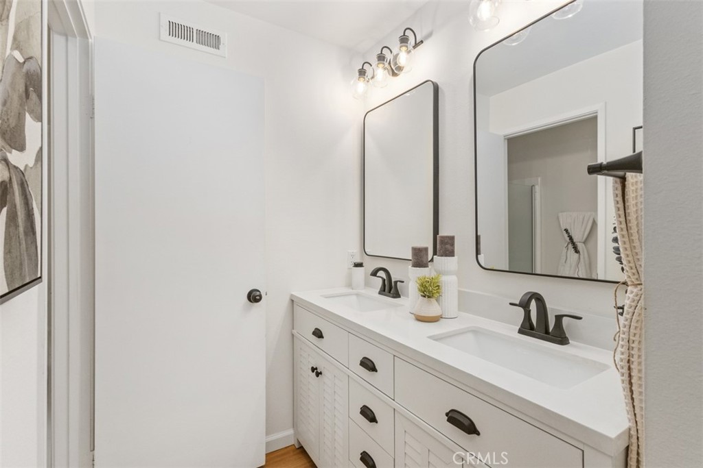 56 Windjammer Irvine, CA 92614 - Photo 15 of 31 a bathroom with double vanity sink and mirror