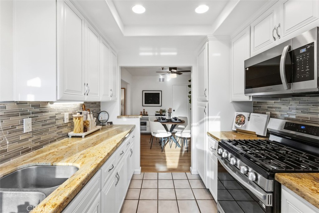 56 Windjammer Irvine, CA 92614 - Photo 9 of 31 a kitchen with a sink a stove and cabinets