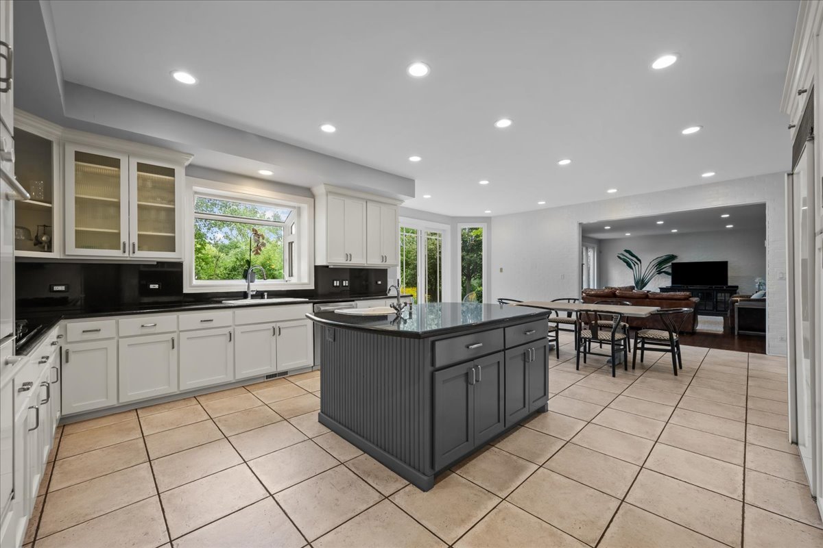 101 Crestview Drive Deerfield, IL 60015 - Photo 12 of 37 a kitchen with stainless steel appliances kitchen island granite countertop a sink and cabinets