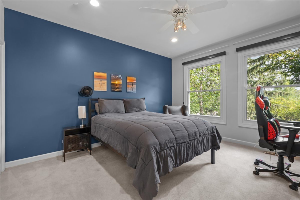 101 Crestview Drive Deerfield, IL 60015 - Photo 24 of 37 a bedroom with a bed a chandelier and a window