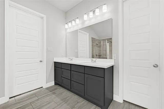 a bathroom with a sink vanity and a mirror