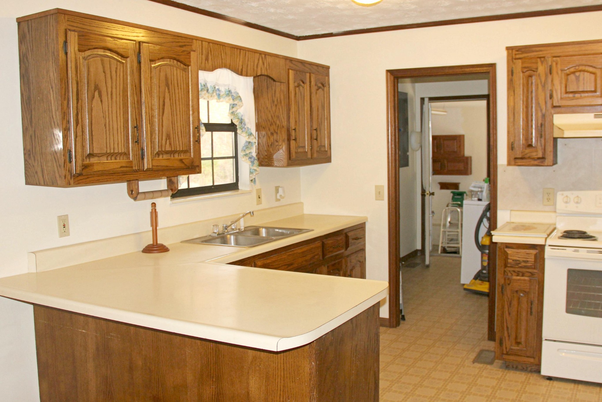 653 Laurel Bluff Road Kingston, TN 37763 - Photo 7 of 20 a kitchen with a sink a stove and a refrigerator