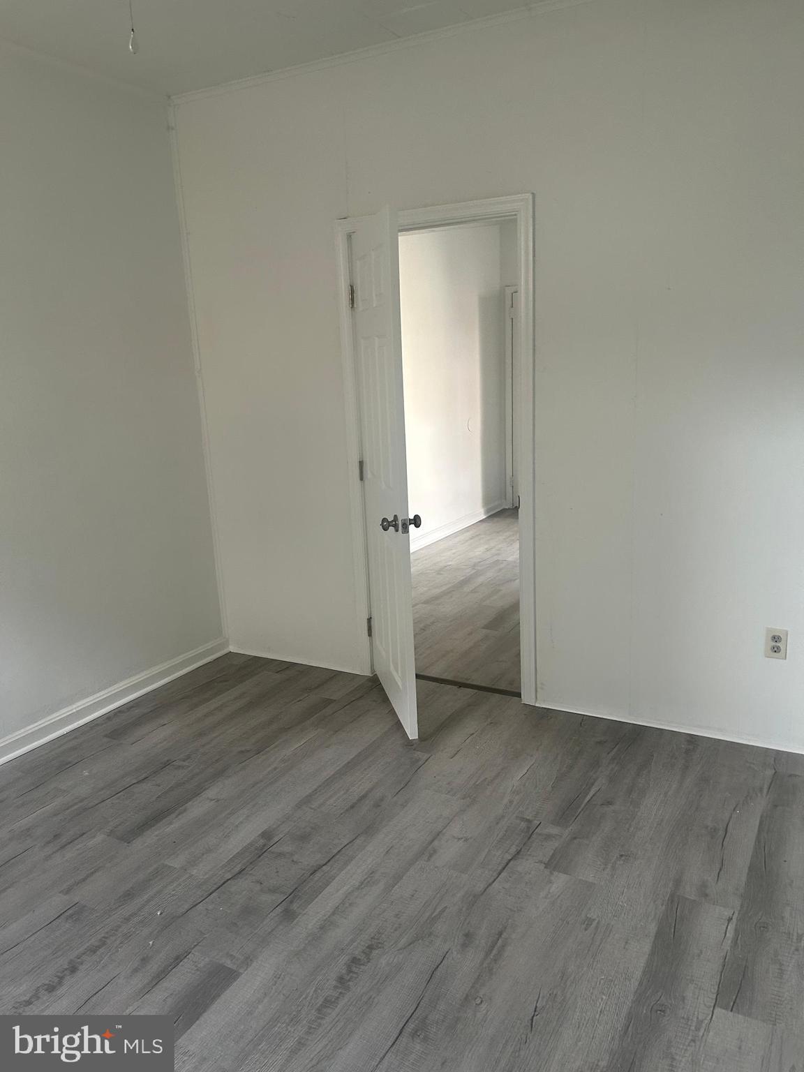 1550 Ruan Street Philadelphia, PA 19124 - Photo 7 of 22 an empty room with wooden floor & mirror