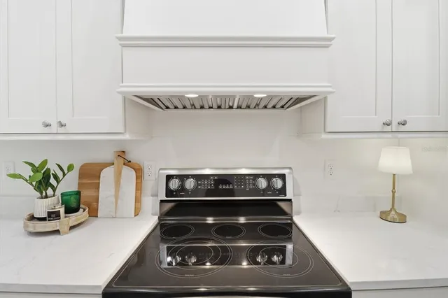 a kitchen with a stove and cabinets