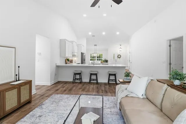 a living room with furniture and kitchen view