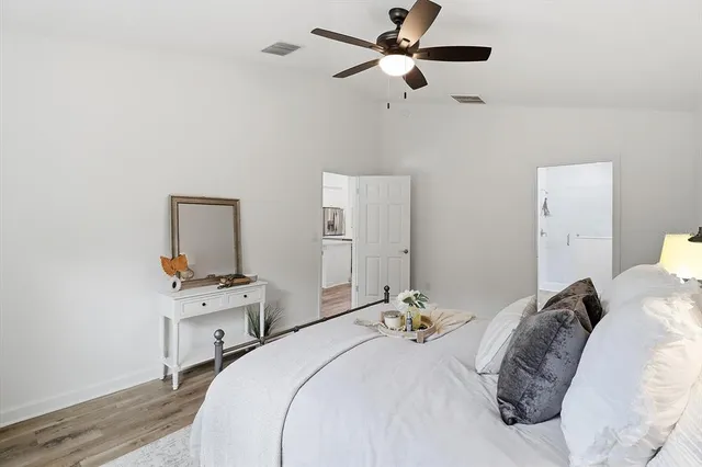 a bedroom with a bed and a chandelier