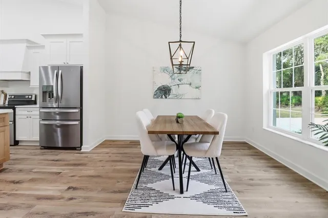 a view of a dining room with furniture window and wooden floor