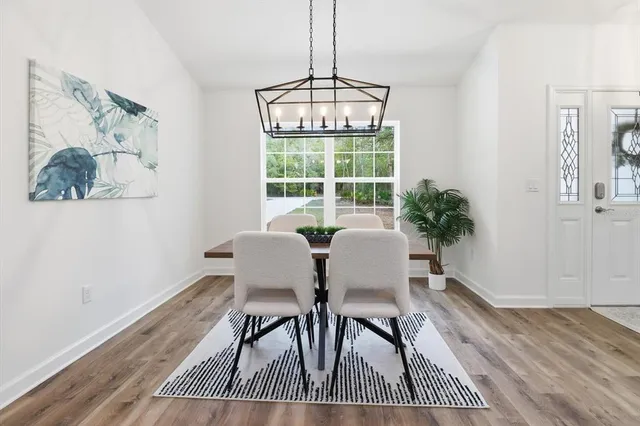 a view of a dining room with furniture window and wooden floor