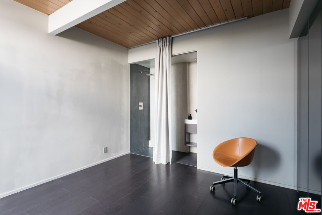 2135 Ridgemont Drive Los Angeles, CA 90046 - Photo 15 of 26 a view of a livingroom with wooden floor and a chandelier