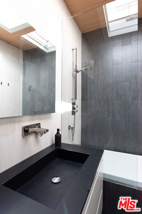 2135 Ridgemont Drive Los Angeles, CA 90046 - Photo 16 of 26 a bathroom with a sink and a mirror