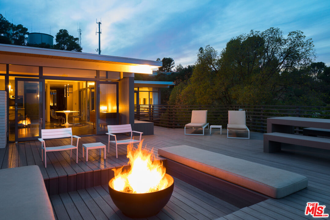 2135 Ridgemont Drive Los Angeles, CA 90046 - Photo 26 of 26 a outdoor space with the couches and dining table with potted plants