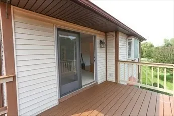 a balcony with wooden floor and city view
