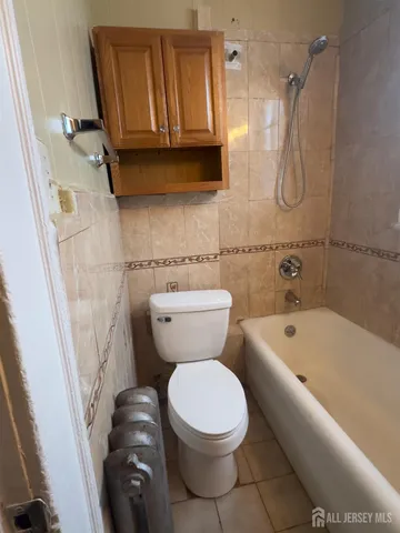 a bathroom with a toilet a sink and bathtub