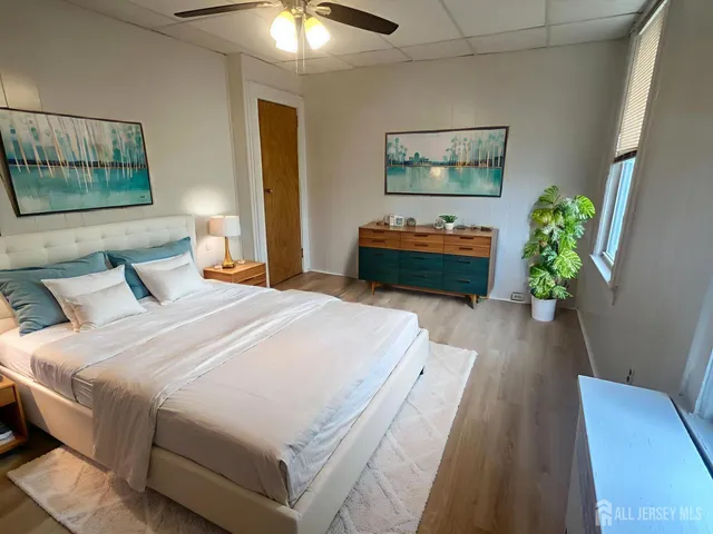 a bedroom with bed and a chandelier