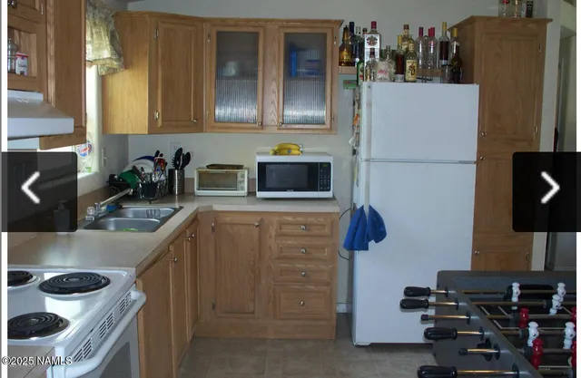 a kitchen with stainless steel appliances a refrigerator and a stove top oven