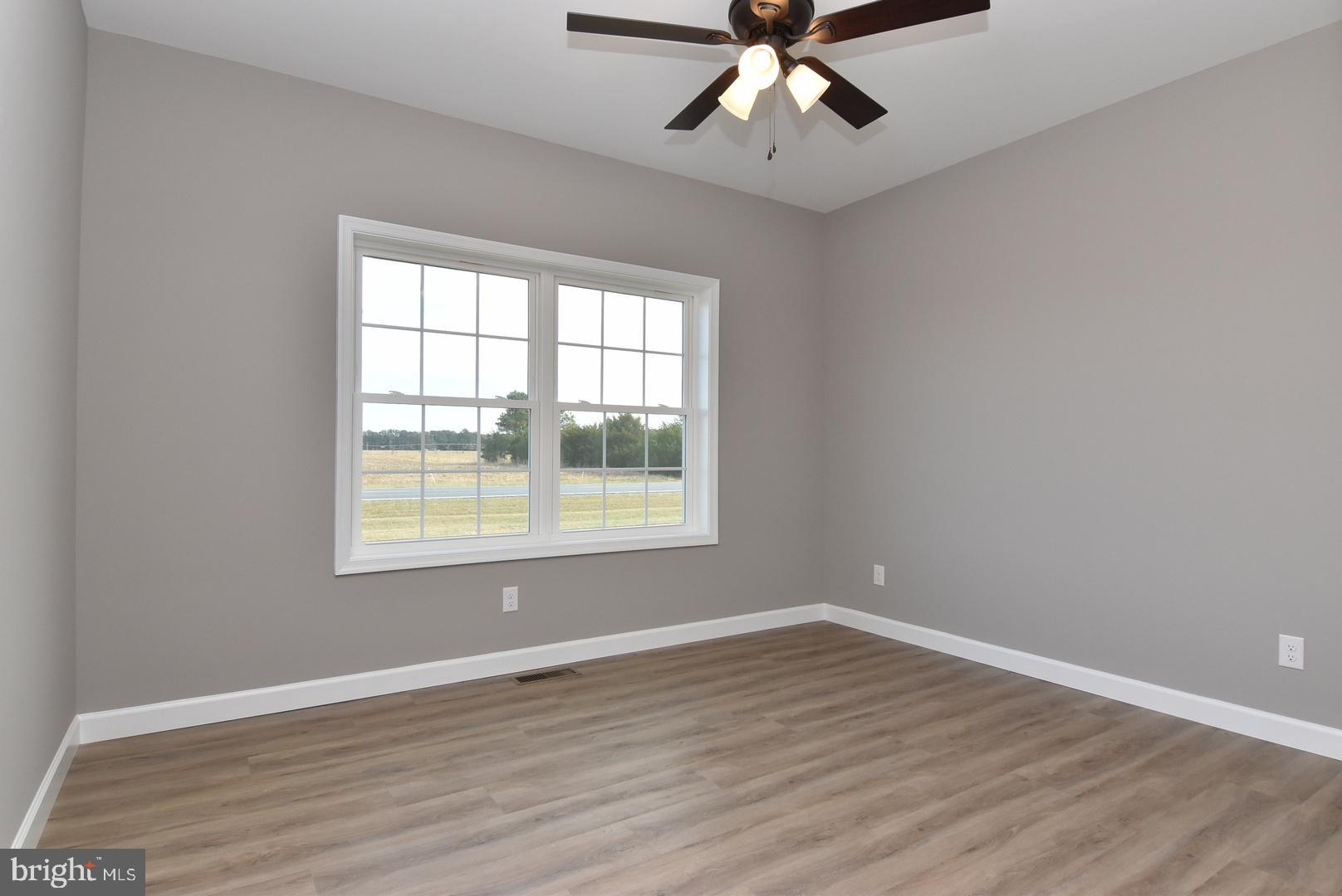 36078 Columbia Road Delmar, DE 19940 - Photo 12 of 20 a view of an empty room with wooden floor and a window