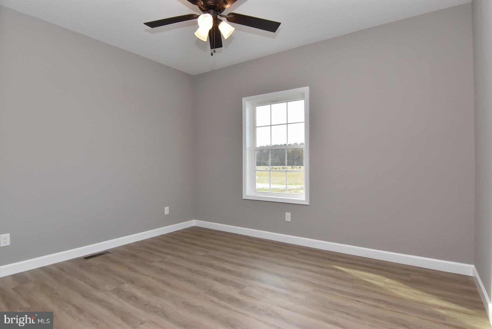 36078 Columbia Road Delmar, DE 19940 - Photo 13 of 20 wooden floor in an empty room with a window