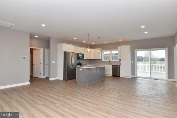 a kitchen with stainless steel appliances kitchen island wooden cabinets and granite counter tops