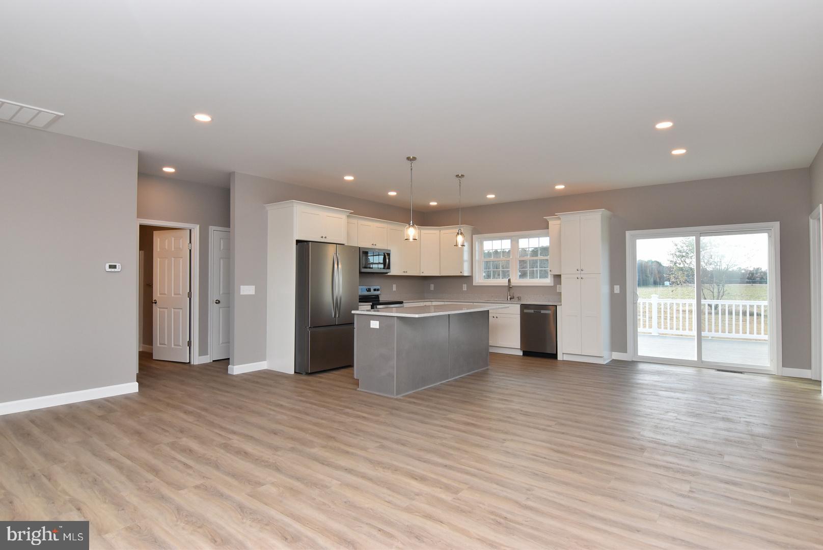 36078 Columbia Road Delmar, DE 19940 - Photo 3 of 20 a kitchen with stainless steel appliances kitchen island wooden cabinets and granite counter tops