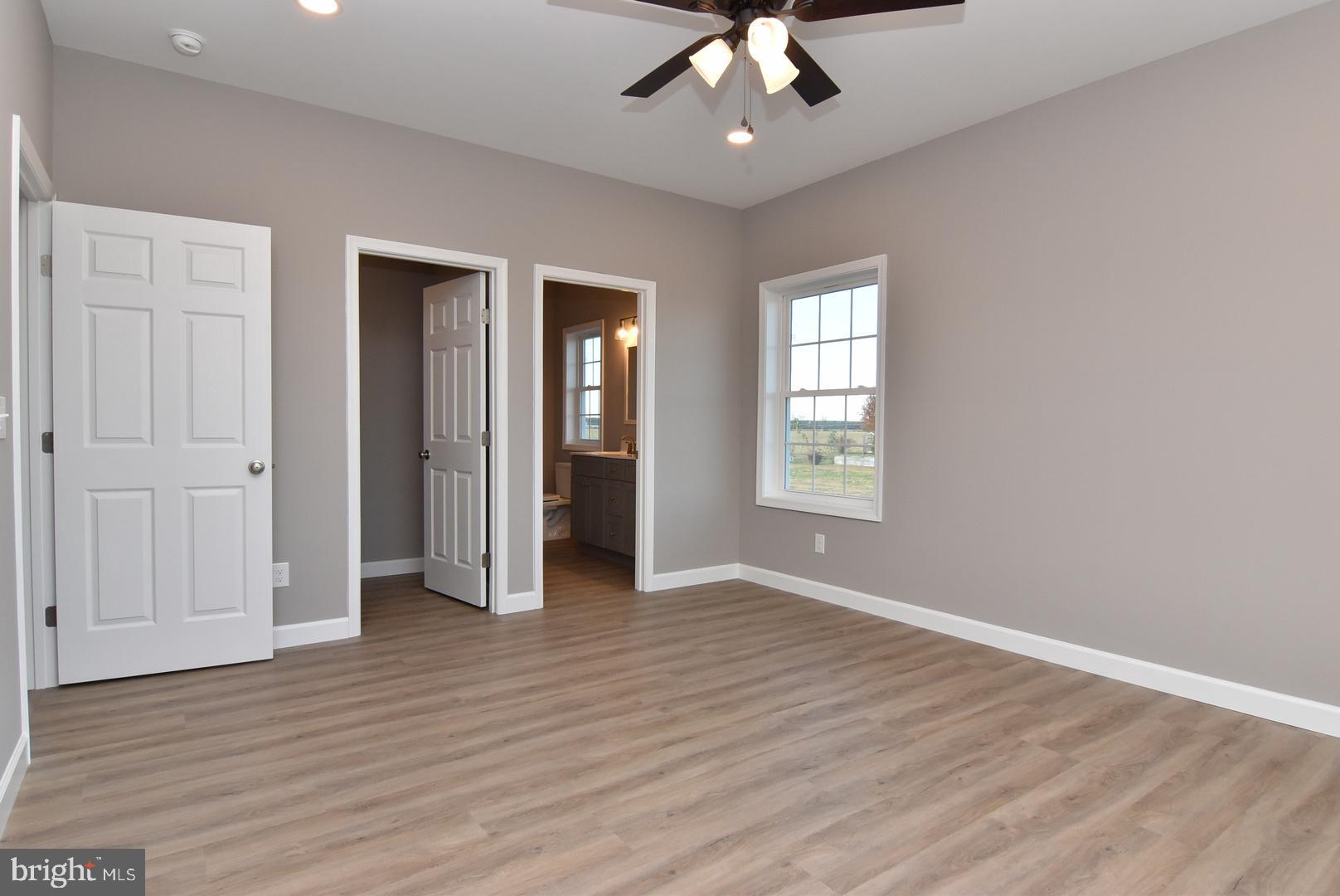 36078 Columbia Road Delmar, DE 19940 - Photo 9 of 20 an empty room with wooden floor chandelier and windows