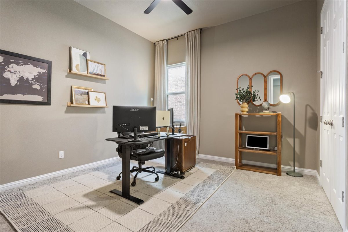 424 Millard Street Georgetown, TX 78628 - Photo 29 of 37 A dedicated home office provides a quiet space for productivity with soft carpeting and natural light.