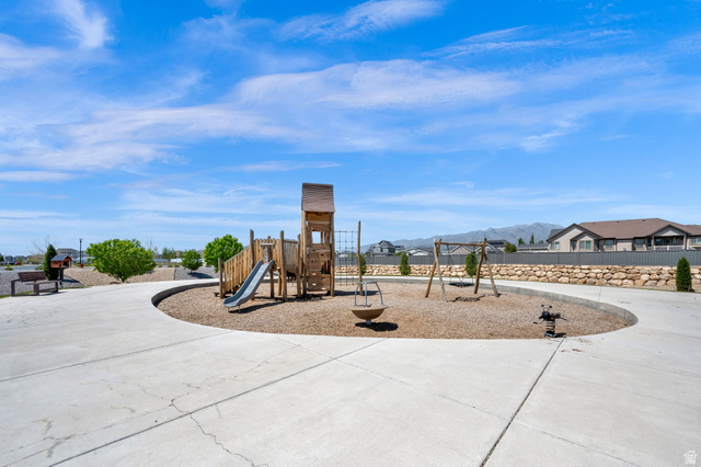 6120 North Sheps Ridge Road Eagle Mountain, UT 84005 - Photo 20 of 43 Community park featuring a play structure with a slide, swing set, and spring rider