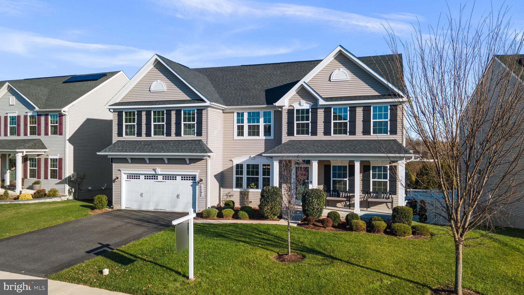 5245 Red Maple Drive Frederick, MD 21703 - Photo 2 of 49 a front view of a house with a yard