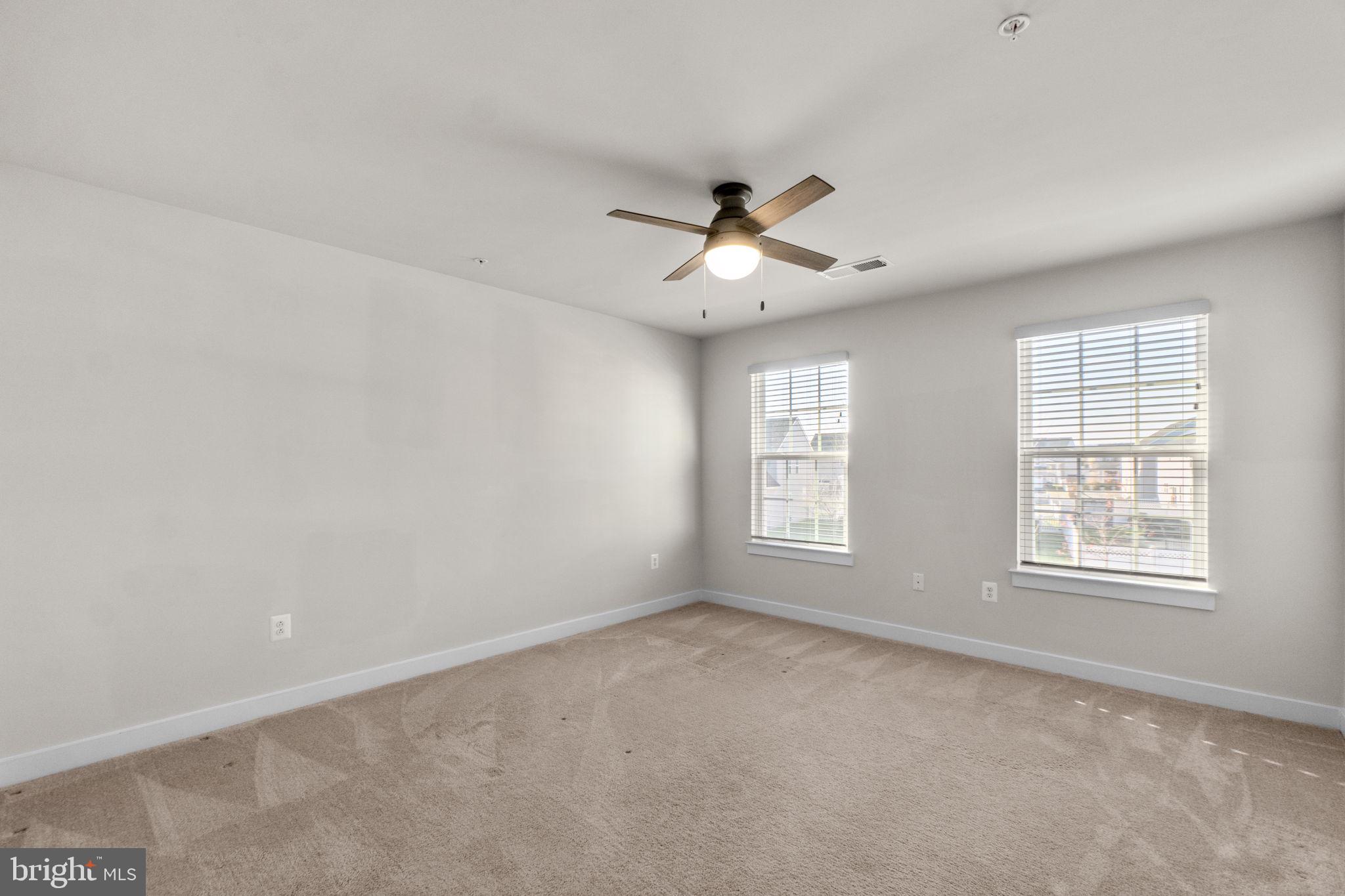 5245 Red Maple Drive Frederick, MD 21703 - Photo 28 of 49 an empty room with windows and ceiling fan