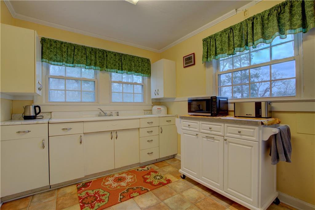 5 Vineland Drive Northwest Rome, GA 30165 - Photo 42 of 54 a kitchen with cabinets appliances and a window