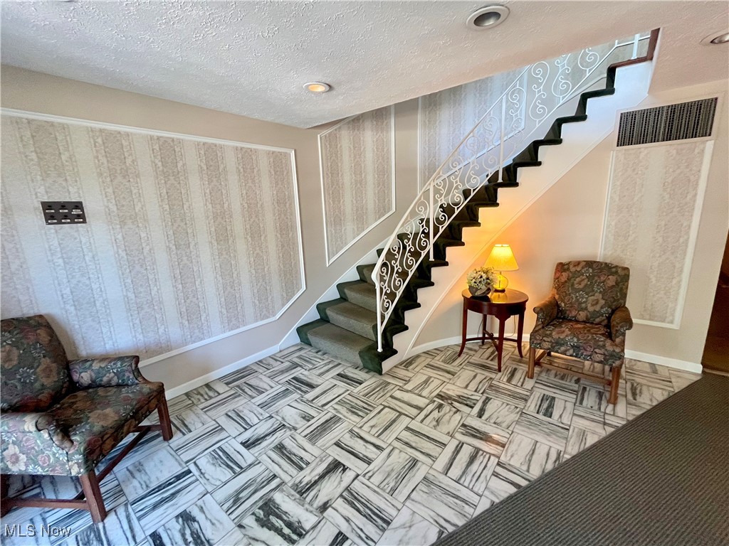22701 Center Ridge Road, Unit 201 Rocky River, OH 44116 - Photo 35 of 37 Staircase featuring a textured ceiling