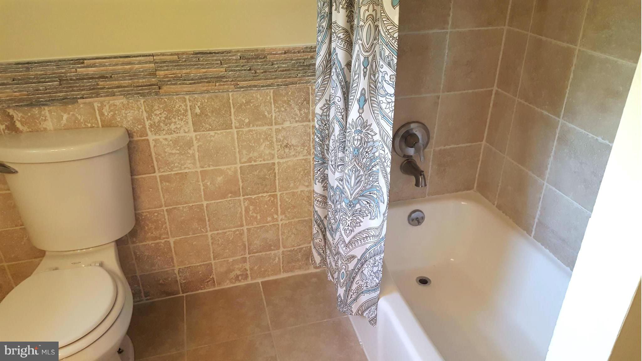 6009 Poplar Road St. Leonard, MD 20685 - Photo 2 of 26 a bathroom with a toilet and shower