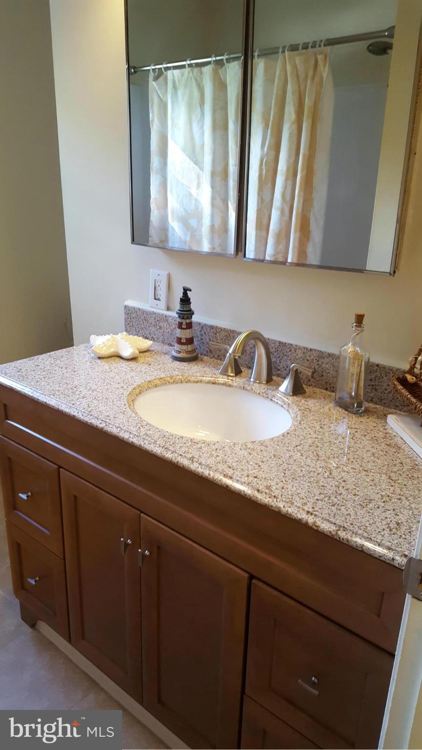 6009 Poplar Road St. Leonard, MD 20685 - Photo 12 of 26 a bathroom with a granite countertop sink and a mirror