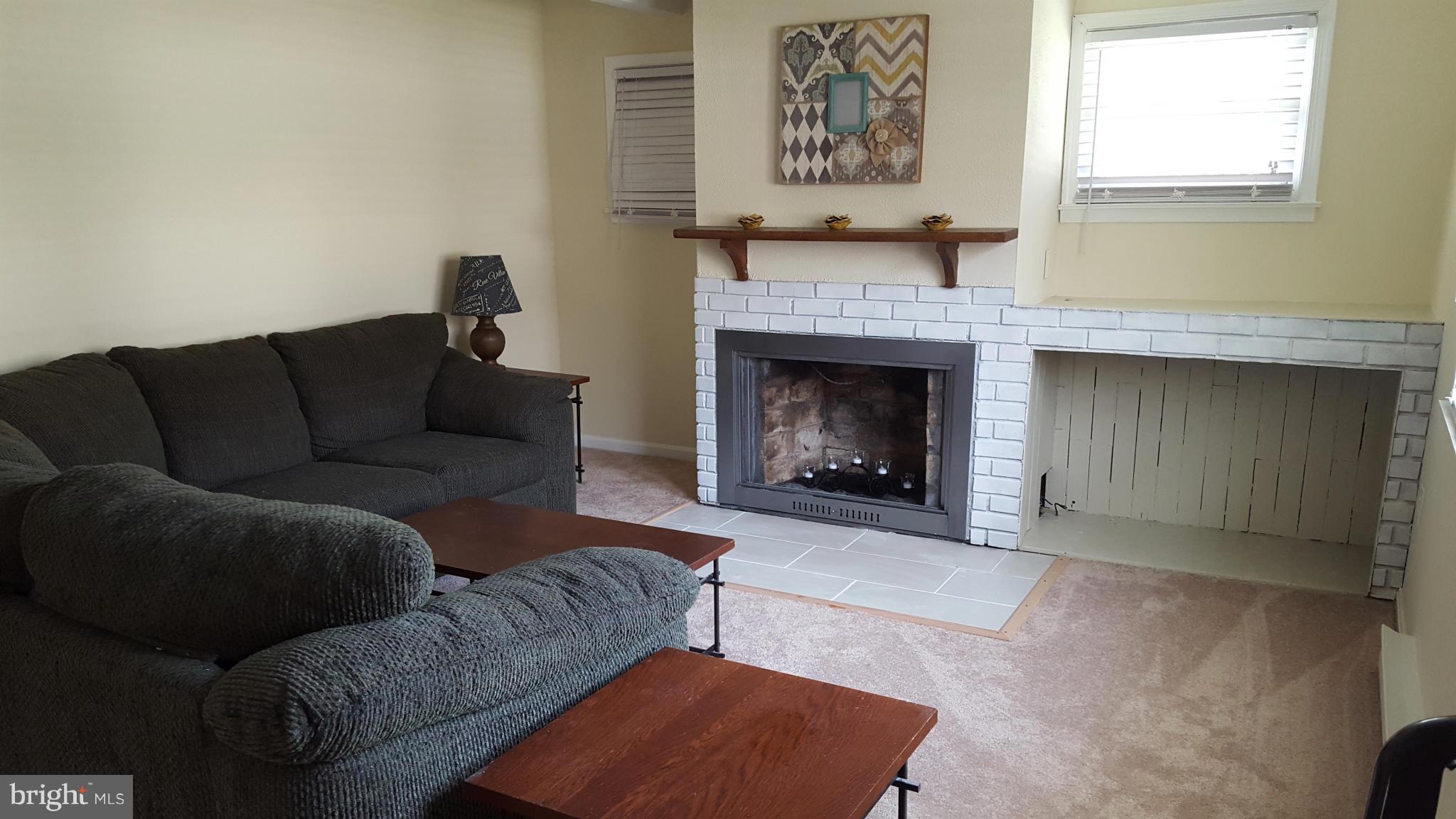 6009 Poplar Road St. Leonard, MD 20685 - Photo 14 of 26 a living room with furniture and a fireplace