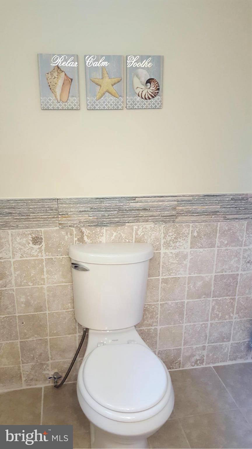6009 Poplar Road St. Leonard, MD 20685 - Photo 19 of 26 a white toilet sitting next to a white wall