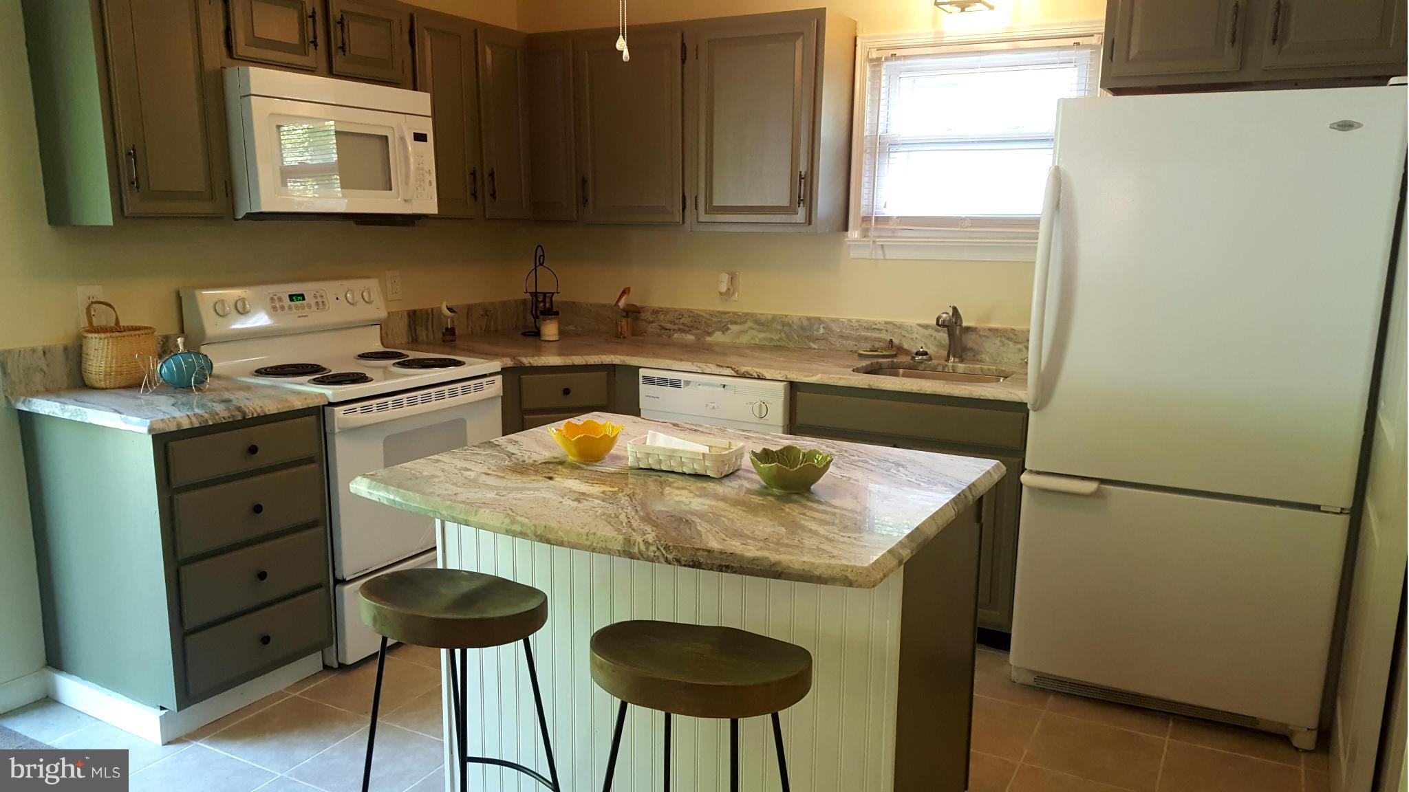 6009 Poplar Road St. Leonard, MD 20685 - Photo 4 of 26 a kitchen with stainless steel appliances granite countertop a sink stove and refrigerator