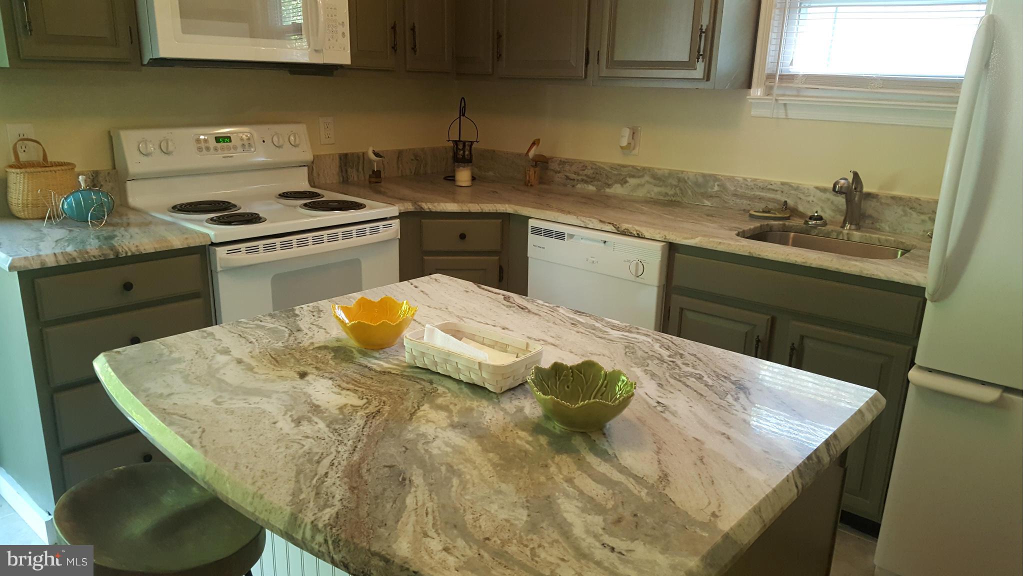 6009 Poplar Road St. Leonard, MD 20685 - Photo 5 of 26 a kitchen with a sink a stove and cabinets