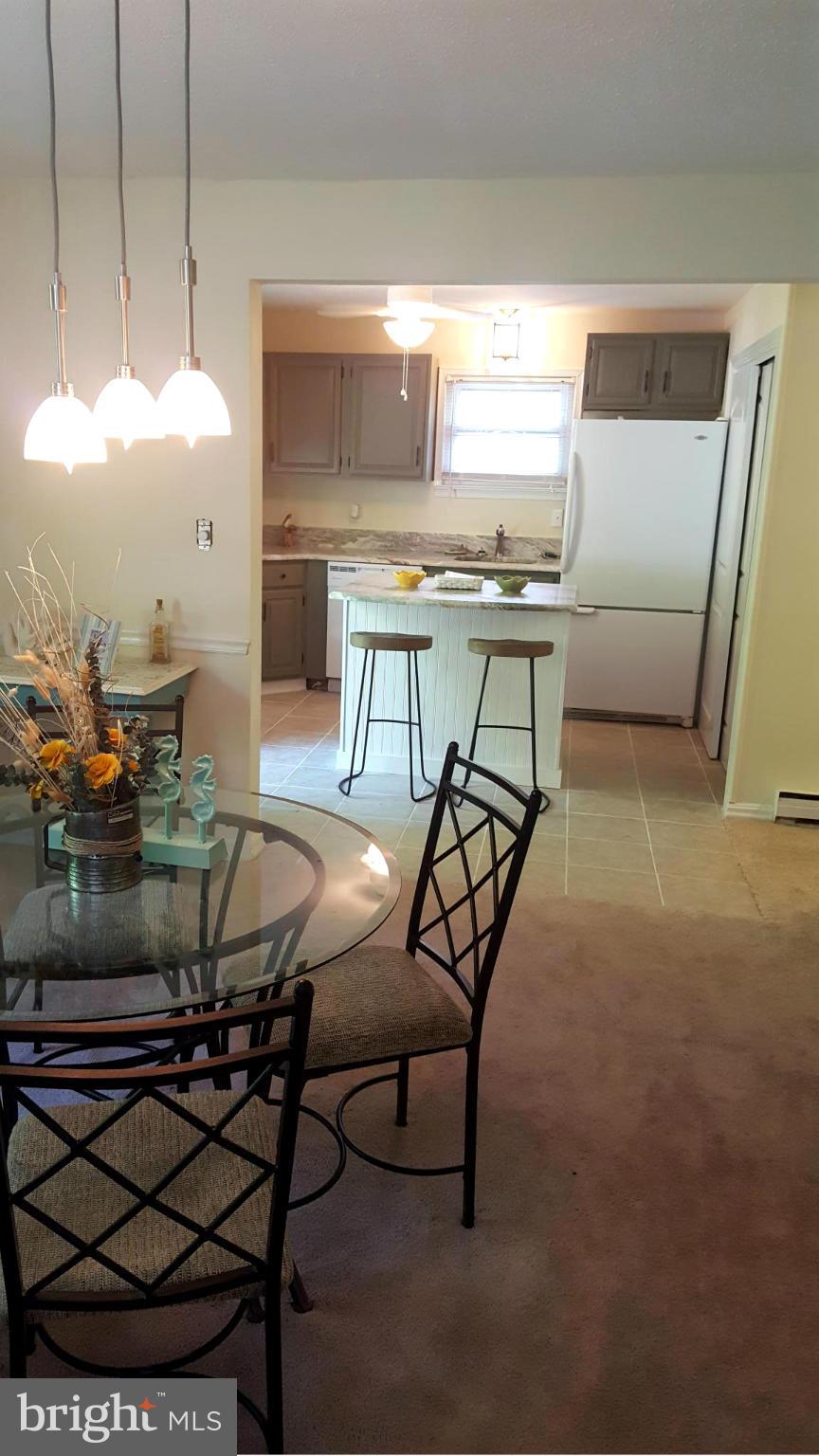 6009 Poplar Road St. Leonard, MD 20685 - Photo 8 of 26 a view of a dining room with furniture and a chandelier