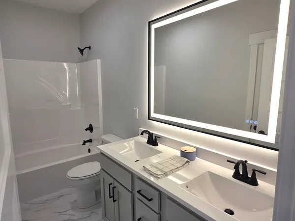 a bathroom with a shower and mirror
