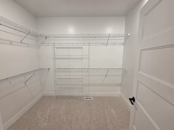 a view of an empty room with a ceiling fan