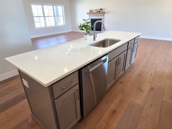 a kitchen with white cabinets and a stove