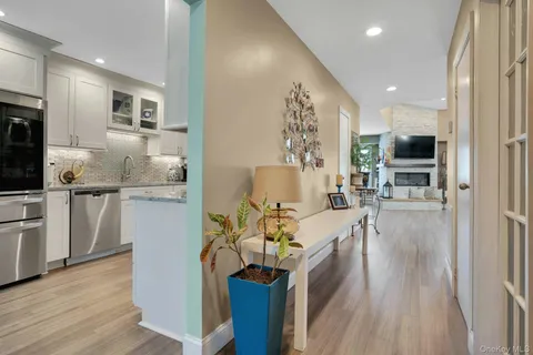 a view of a kitchen with kitchen island stainless steel appliances refrigerator stove microwave and cabinets